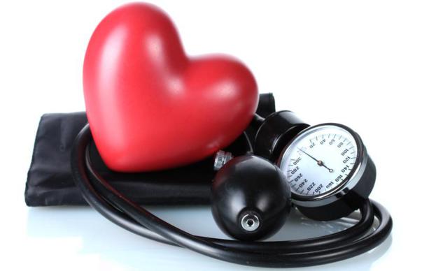 Black tonometer and heart isolated on white